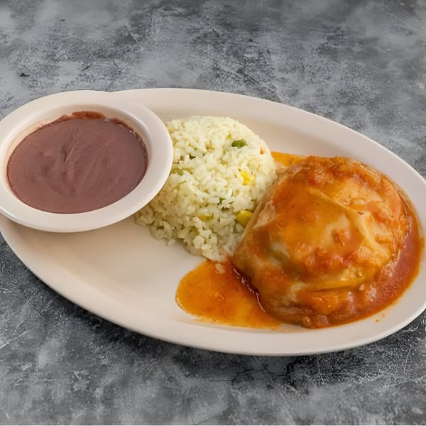 A plate of Mexican food with a tamale covered in red sauce, rice, and refried beans.